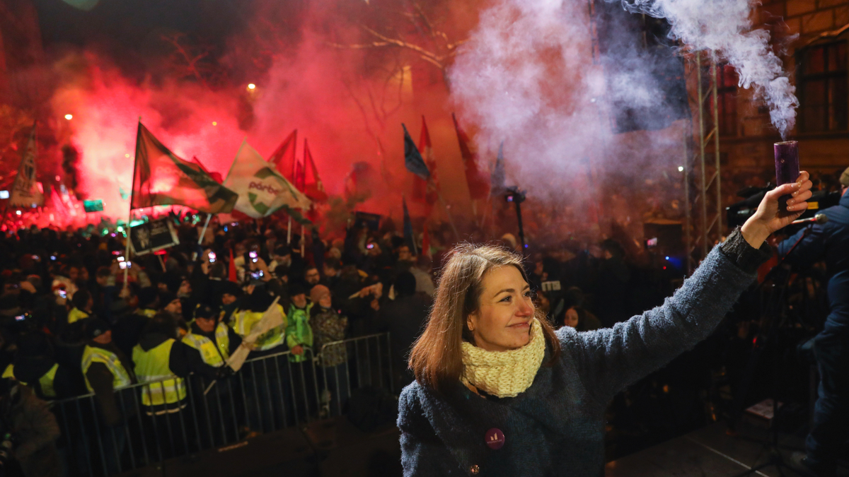 Vice-chairperson of Momentum party Anna Donath holding up a smoke grenade during an anti-government protest in downtown Budapest on Sunday. (Balazs Mohai/MTI via AP)