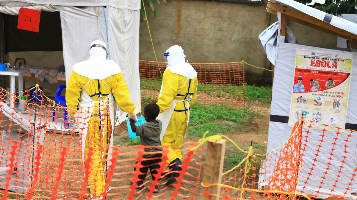 Health workers walk with a boy suspected as having the Ebola virus in Beni, Eastern Congo, in this file photo dated Sept. 9, 2018.