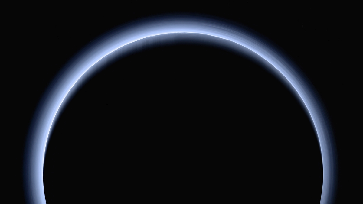 FILE - This image made available by NASA in March 2017 shows Pluto illuminated from behind by the sun as the New Horizons spacecraft travels away from it at a distance of about 120,000 miles (200,000 kilometers). (NASA/Johns Hopkins University Applied Physics Laboratory/Southwest Research Institute via AP)