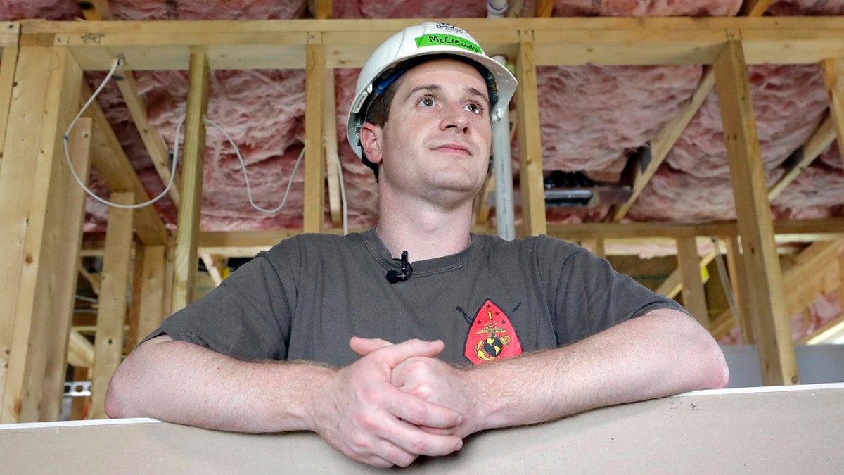 Democratic congressional candidate Dan McCready leans against wallboard as he pauses during a Habitat For Humanity building event in Charlotte, N.C.