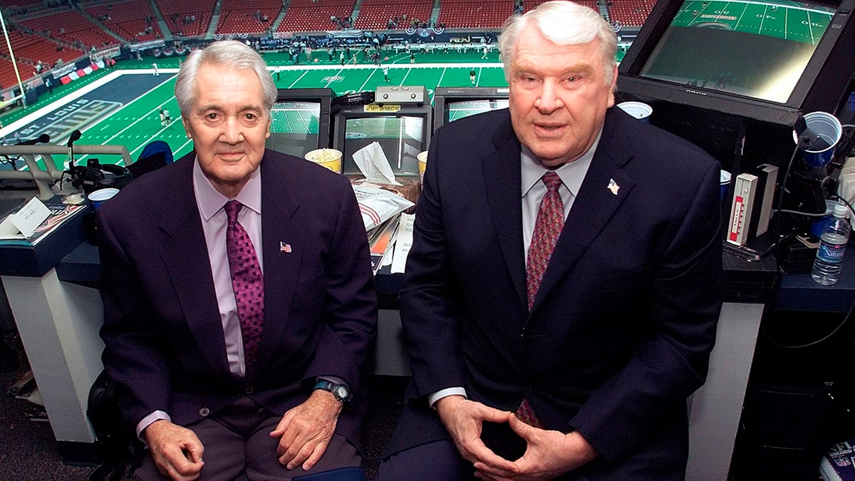 This Jan. 20, 2002, file photo shows Pat Summerall, left, and John Madden, right, in the FOX broadcast booth before the NFC divisional playoff in St. Louis. The hiring of Summerall and Madden as the top broadcast team gave Fox instant credibility. (Associated Press)