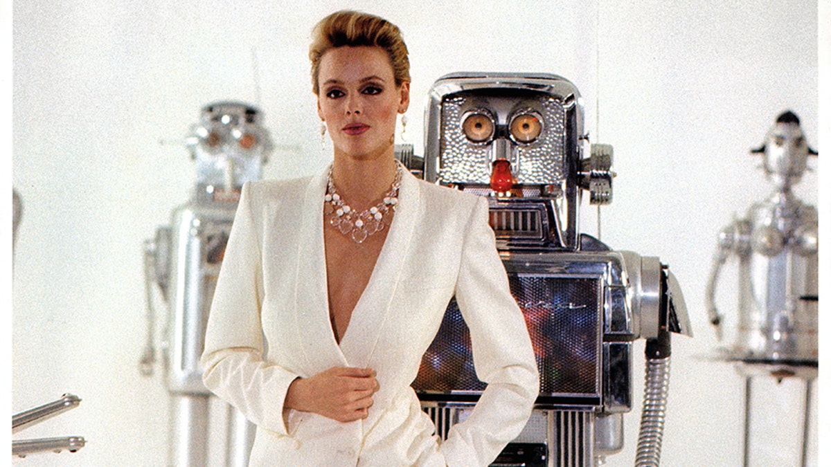 Brigitte Nielsen standing in front of robots in a scene from the film "Cobra," 1986. — Getty