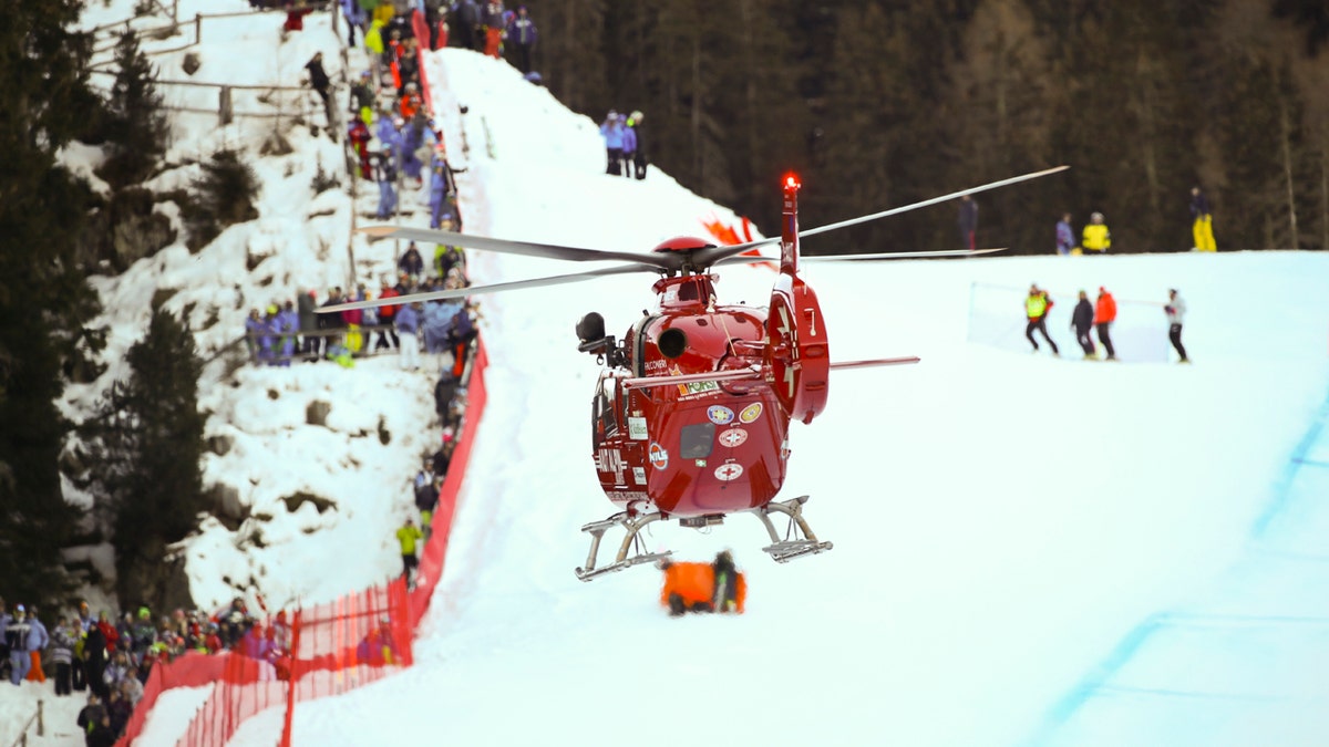 A rescue helicopter leaves with on board Switzerland's Marc Gisin after he crashed on the course during a men's World Cup downhill, in Val Gardena, Italy, Saturday, Dec. 15, 2018.
