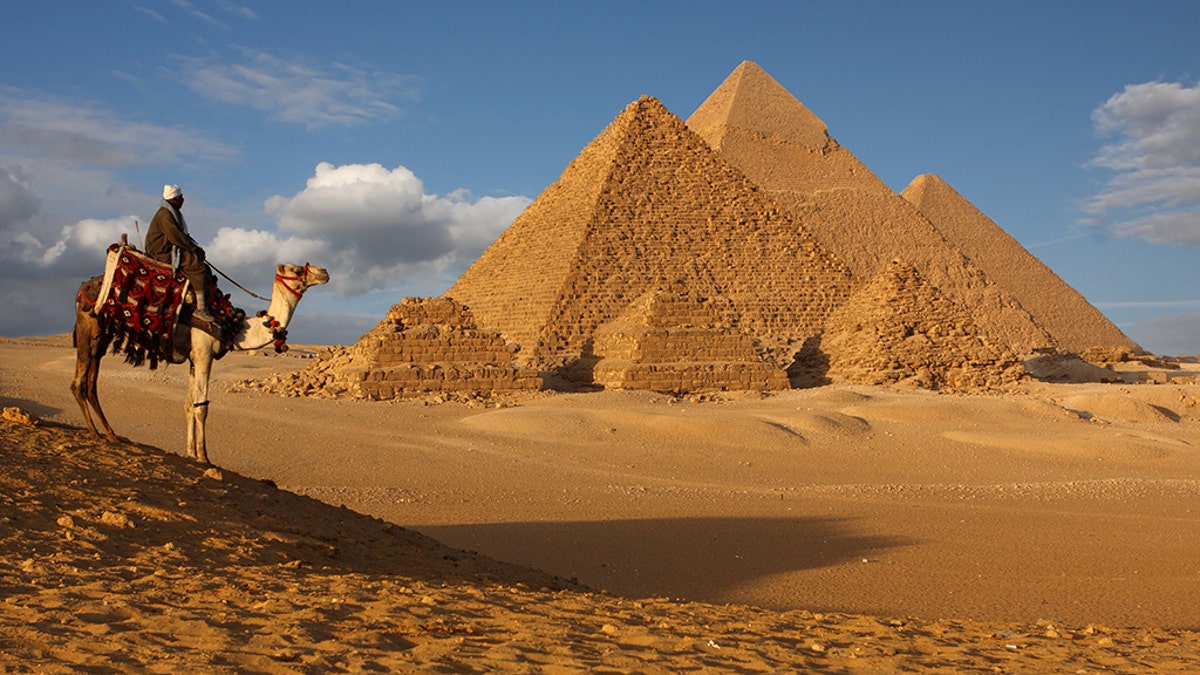 Egyptian security officials say a roadside bomb has hit a tourist bus in an area near the Giza Pyramids, killing at least two people and wounding 12 others.