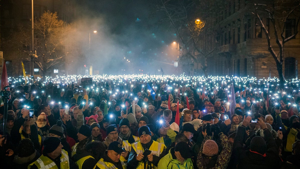 Anti-government demonstrators lighting up their phones during their protest in downtown Budapest on Sunday. (Zoltan Balogh/MTI via AP)