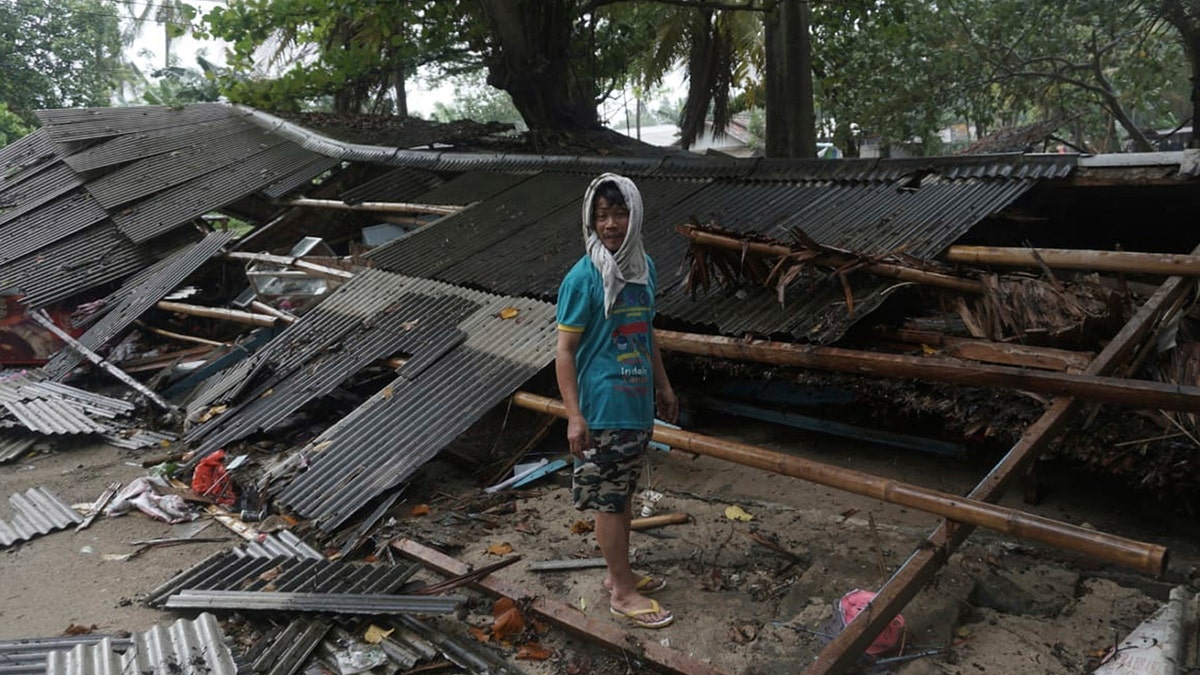 A man inspects his house which was damaged by a tsunami, in Carita, Indonesia, Sunday, Dec. 23, 2018. (Associated Press)