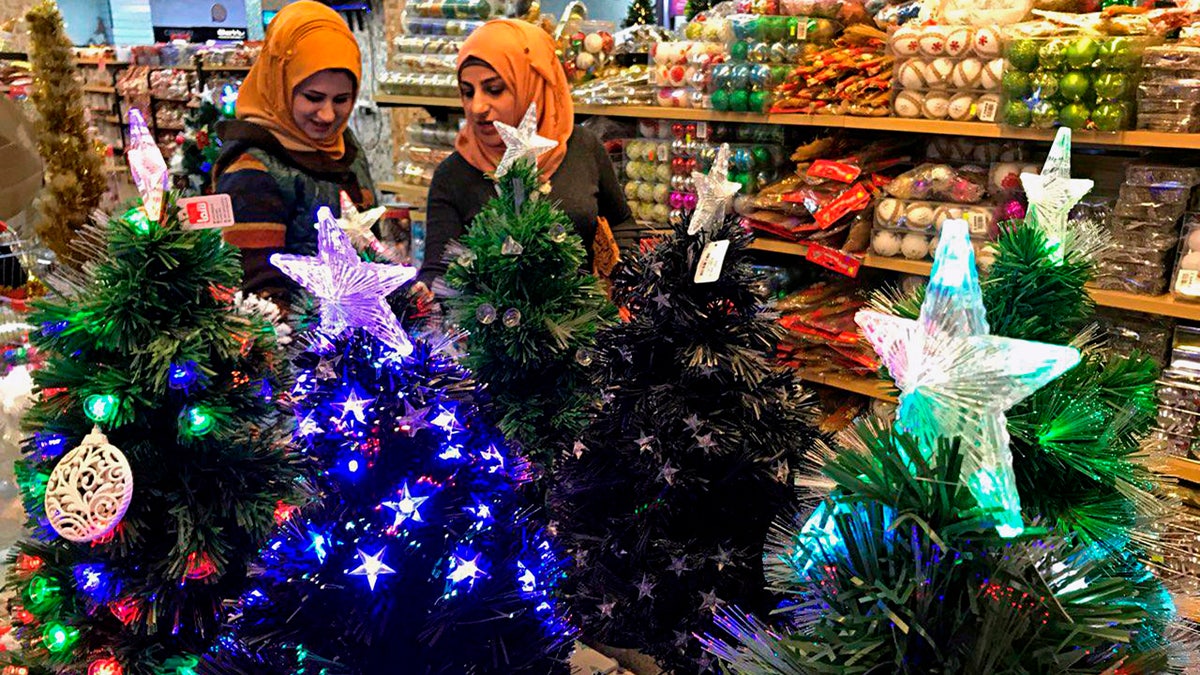 Iraqis shop for Christmas decorations in Baghdad, Iraq, Monday, Dec. 24, 2018. (AP Photo/Ali Abdul Hassan)