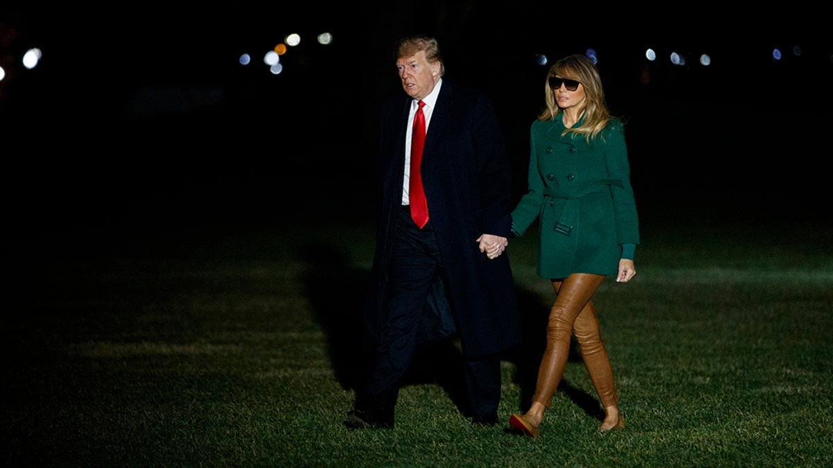 President Donald Trump and first lady Melania Trump arrive on the South Lawn of the White House after making a surprise visit to troops in Iraq, Thursday, Dec. 27, 2018, in Washington. (AP Photo/Evan Vucci)