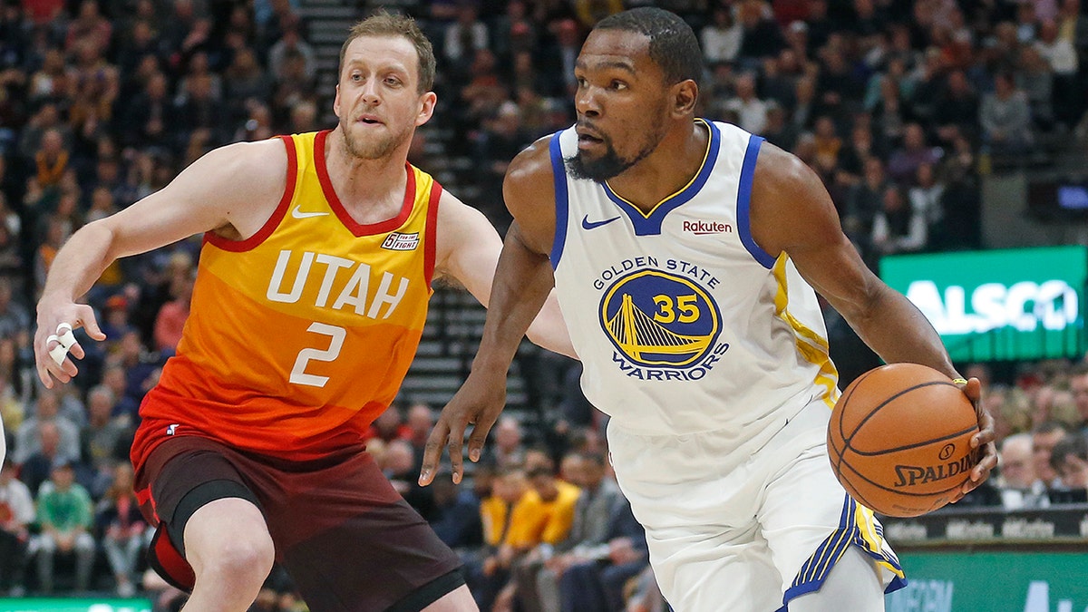 Golden State Warriors forward Kevin Durant (35) drives around Utah Jazz forward Joe Ingles (2) in the first half during an NBA basketball game Wednesday Dec. 19, 2018, in Salt Lake City. (Associated Press)