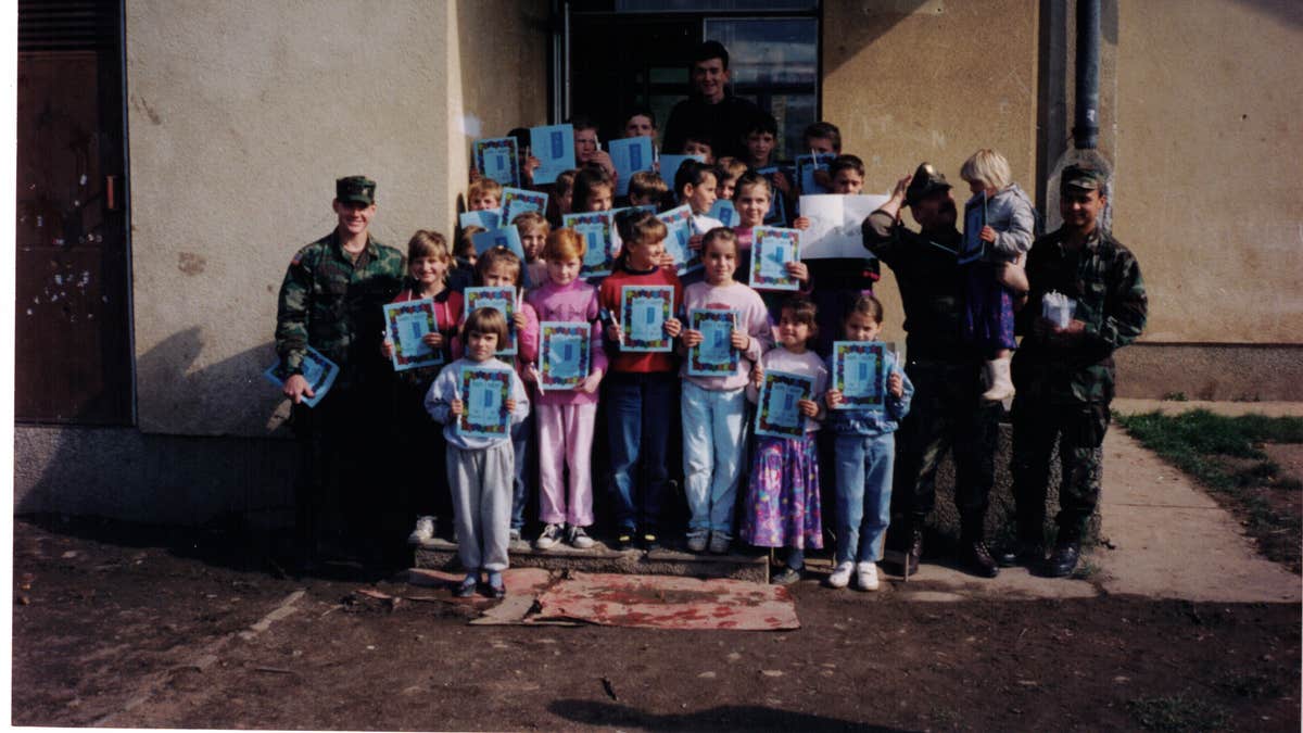 Mine strikes in post-war Bosnia was very high among children. Chad Storlie's team "adopted" a small village in central Bosnia and we brought coloring books, markers, paper, and other supplies to their school. This is in 1996, a Romanian soldier is second from the right. (Courtesy of the author)