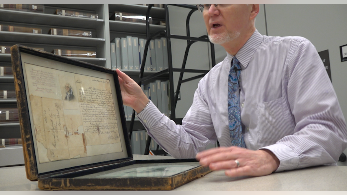 Lee Arnold, Director of the Historical Society of Pennsylvania, shows off George Washington's hair along with letters.