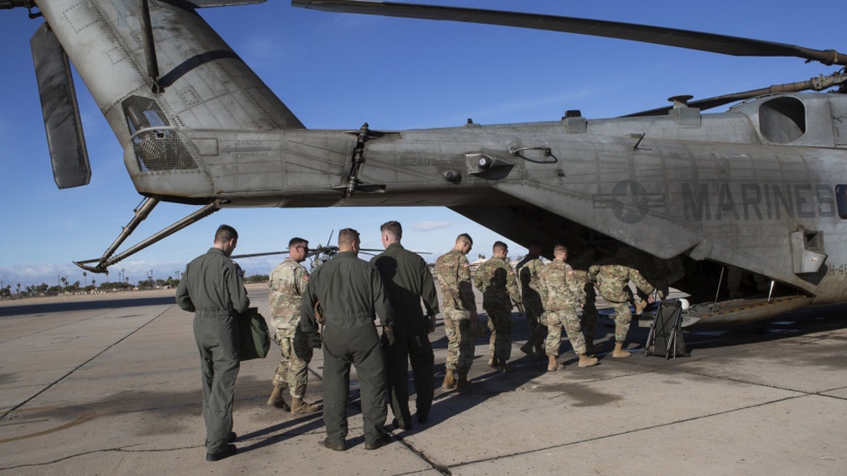 U.S. Soldiers with 19th Engineering Battalion, Special Purpose Marine Air-Ground Task Force 7 (SPMAGTF-7), and U.S. Marines with Marine Heavy Helicopter Squadron 446, SPMAGTF-7, board a CH-53E Super Stallion at Naval Air Facility El Centro, Nov. 30, 2018.