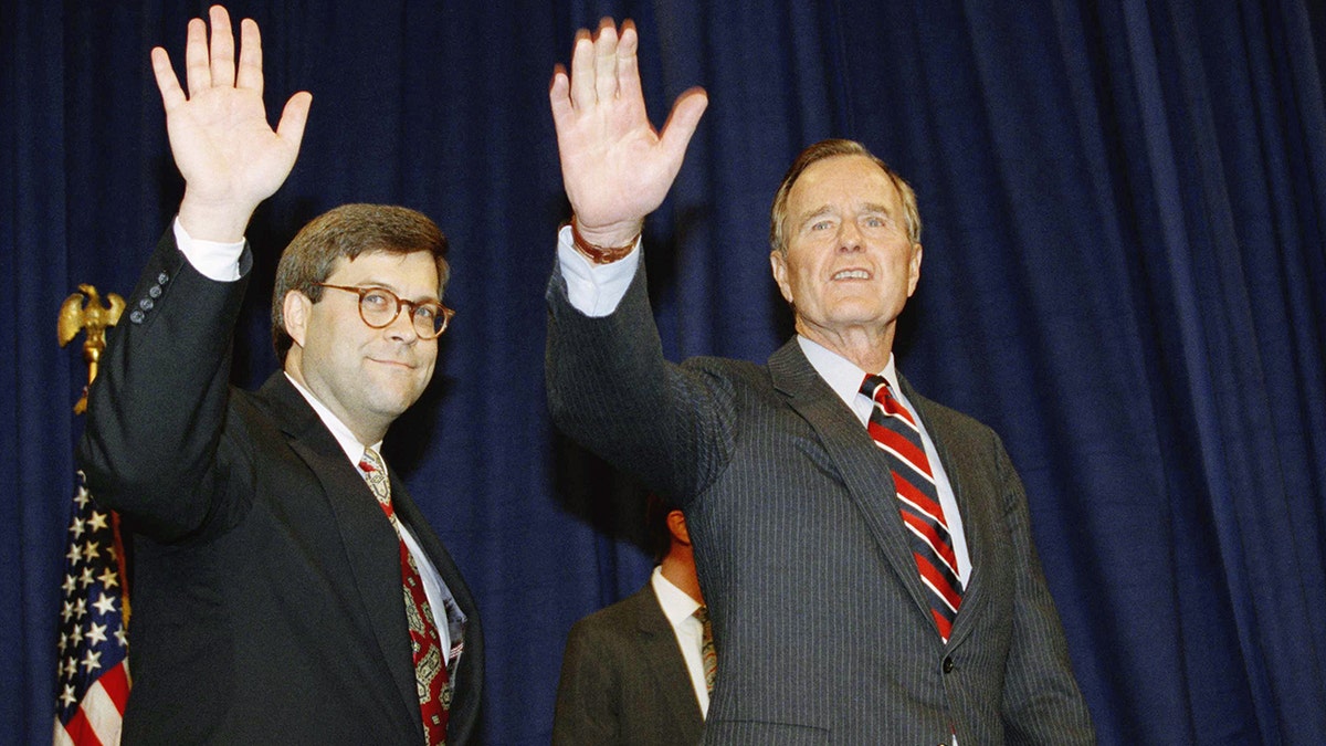 William Barr and former President George H. W. Bush wave