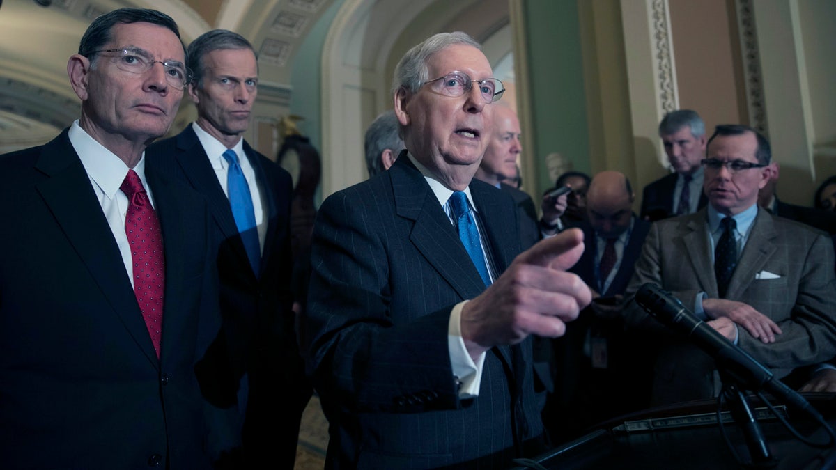 Senate Majority Leader Mitch McConnell, R-Ky., joined from left by Sen. John Barrasso, R-Wyo., and Sen. John Thune, R-S.D., speak at the Capitol Tuesday.  (AP Photo/J. Scott Applewhite)