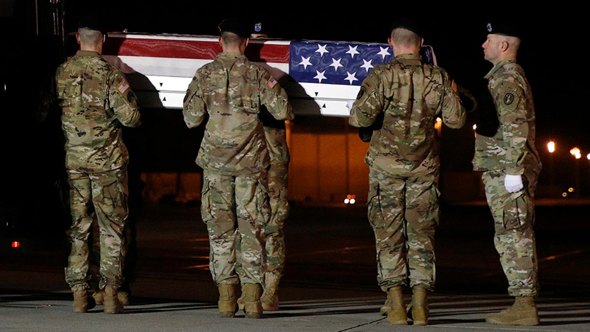 A U.S. Army team prepares to place a transfer case containing the remains of Capt. Andrew P. Ross into a vehicle at Dover Air Force Base, in Delaware, Friday. He was one of the four victims of the Afghanistan roadside bomb attack.