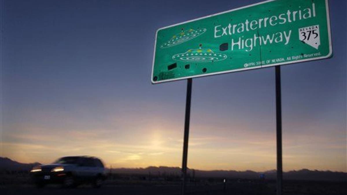 In this April 10, 2002, file photo, a car moves along the Extraterrestrial Highway near Rachel, Nev., the closest town to Area 51. (AP Photo/Laura Rauch, File)