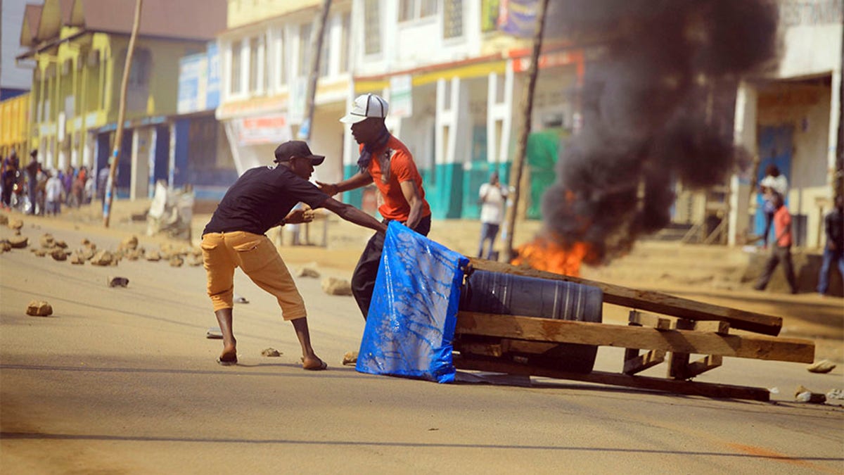 Protesters set up a barricade in the Eastern Congolese city of Beni on Thursday. Police in eastern Congo have fired live ammunition and tear gas to disperse dozens of people protesting a presidential election delay that means more than 1 million votes will not count. 