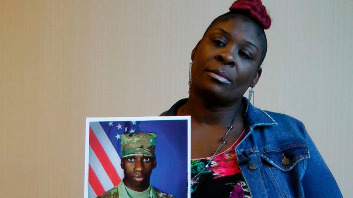 April Pipkins holds a photograph of her son Emantic “EJ” Bradford Jr. who was shot to death by a police officer in a mall on Thanksgiving night.