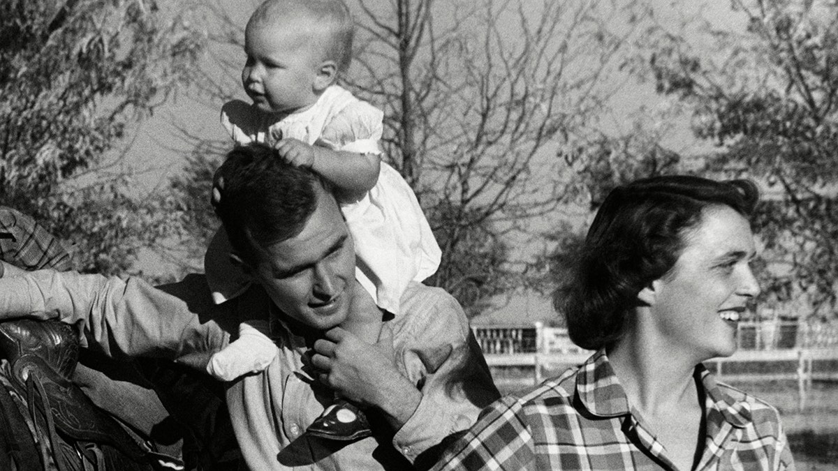 George H. W. Bush with his wife, Barbara, and their children Pauline and George W. in the yard of their Midlands, Texas ranch. 