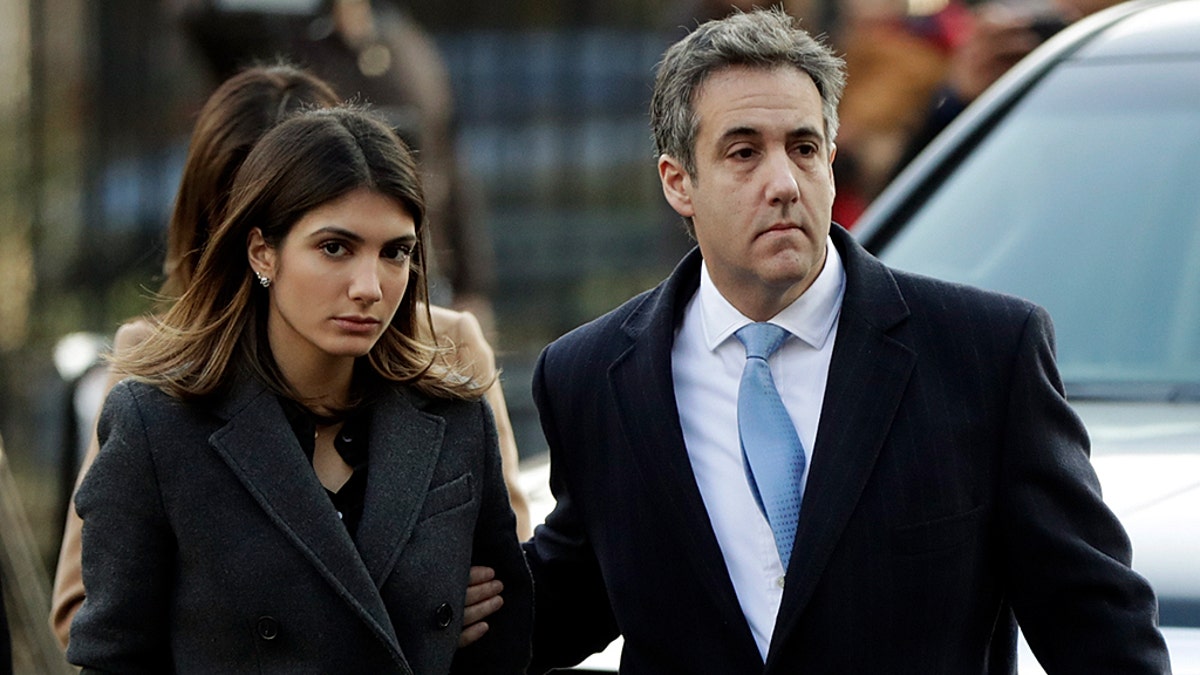 Michael Cohen, right, President Donald Trump's former lawyer, arrives at federal court for his sentencing for dodging taxes, lying to Congress and violating campaign finance laws in New York on Wednesday, Dec. 12, 2018. (AP Photo/Julio Cortez)