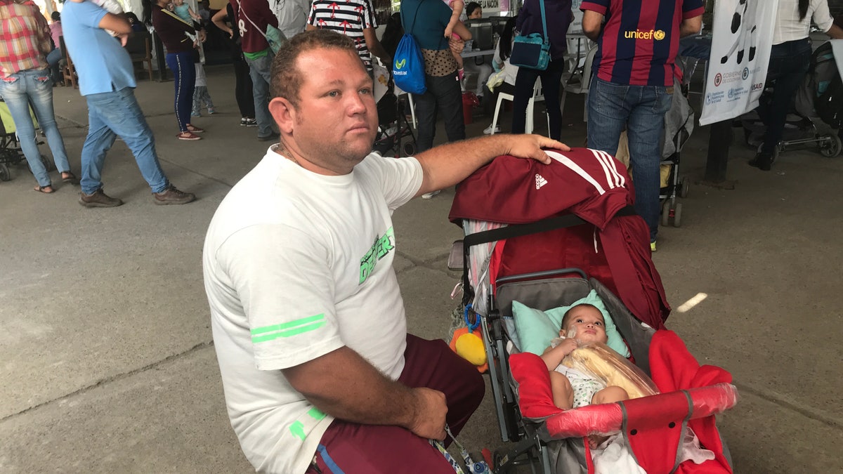 Alberto Camacho, 35 with his five-month-old daughter crosses from Venezuela to Colombia to find healthcare and vaccines.