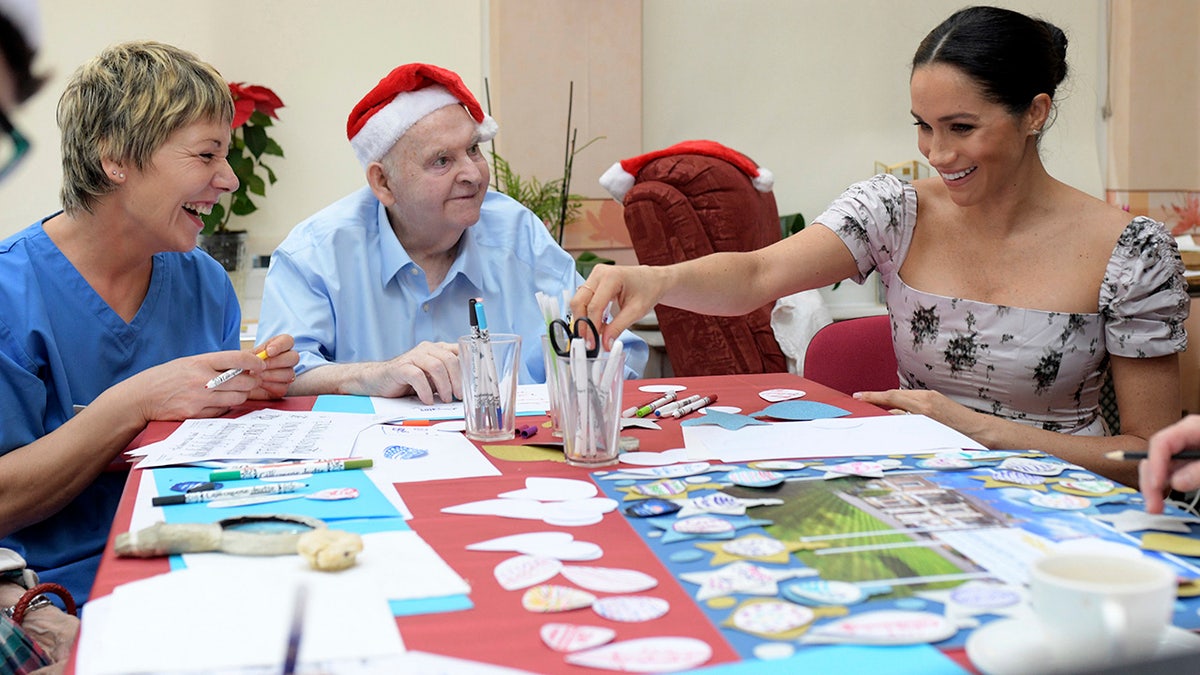 Meghan, the Duchess of Sussex visits the Royal Variety Charity's residential nursing and care home Brinsworth House, in Twickenham, south west London, Tuesday, Dec. 18, 2018. The Royal Variety Charity assists those who have worked professionally in the entertainment industry and are in need of help and assistance as a result of old age, ill-health, or hard times. (Geoff Pugh/Pool via AP)