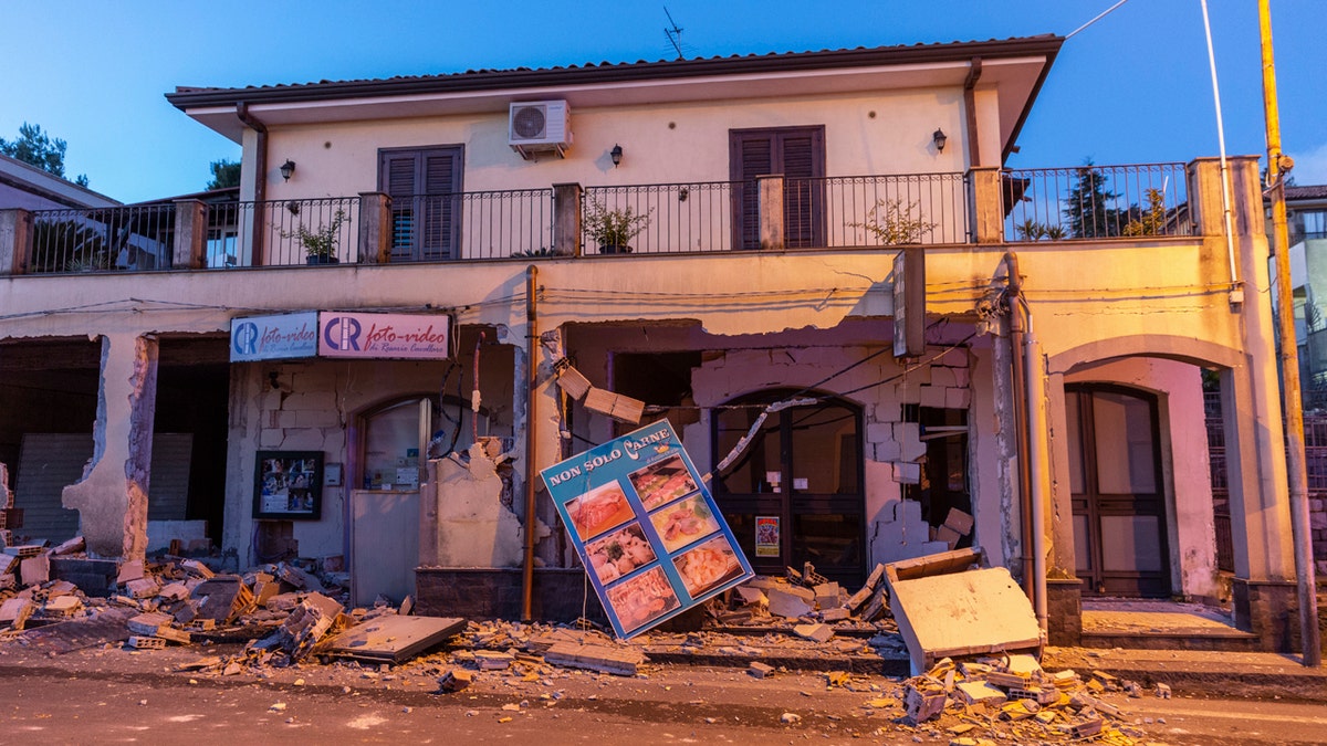 Debris sits on the street in front of a heavily damaged house in Fleri, Sicily Italy, Wednesday, Dec. 26, 2018.