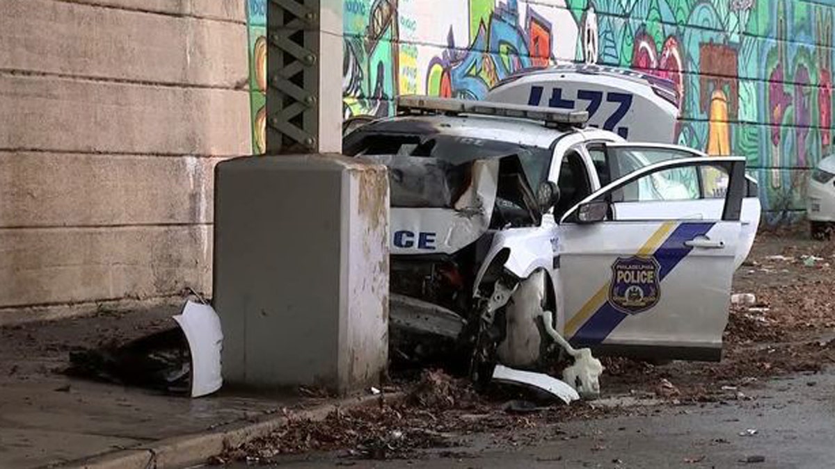 A Philadelphia police officer was pulled from his wrecked cruiser moments before it burst into flames.