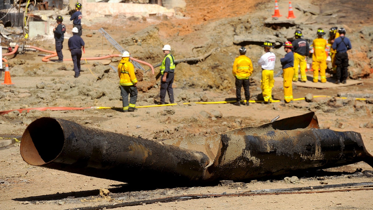 In this Sept. 11, 2010, file photo, a natural gas line lies broken on a San Bruno, Calif., road after a massive explosion. The California Public Utilities Commission said Friday, Dec. 14, 2018, that an investigation by its staff found Pacific Gas &amp; Electric Co. lacked enough employees to fulfill requests to find and mark natural gas pipelines(AP Photo/Noah Berger, File)