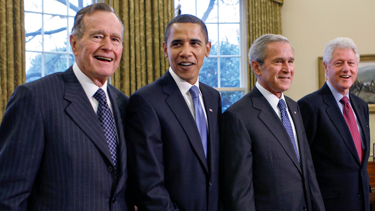 Former President George H.W. Bush, left, joins then President-elect Barack Obama, President George W. Bush, former President Bill Clinton and former President Jimmy Carter in the Oval Office in 2009. (AP Photo/J. Scott Applewhite, file)