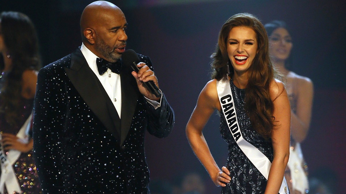 Miss Canada Marta Stepien gestures as host Steve Harvey greets her during the final of 67th Miss Universe competition in Bangkok, Thailand, Monday, Dec. 17, 2018.(Associated Press)