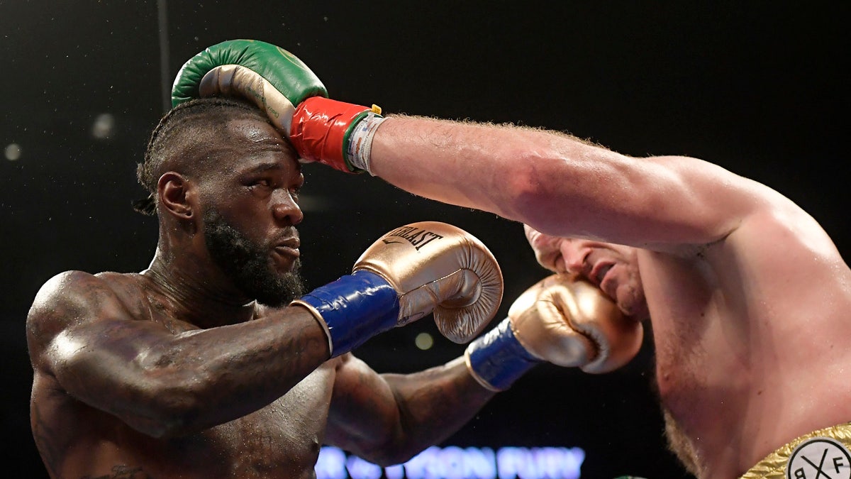 Deontay Wilder, left, and Tyson Fury, of England, trade punches during a WBC heavyweight championship boxing match, Saturday, Dec. 1, 2018, in Los Angeles. (AP Photo/Mark J. Terrill)