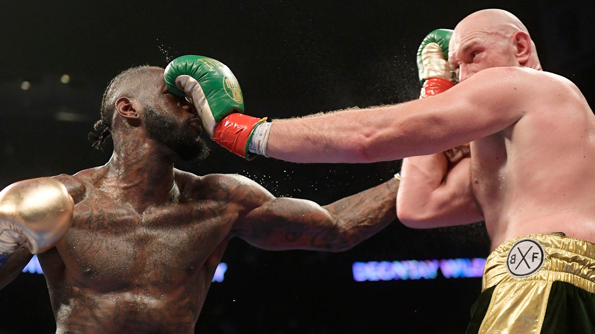 Deontay Wilder, left, and Tyson Fury, of England, trade punches during a WBC heavyweight championship boxing match Saturday, Dec. 1, 2018, in Los Angeles. (AP Photo/Mark J. Terrill)