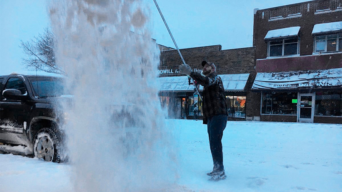 Post-holiday travelers were finding driving difficult as a winter storm dumped heavy snow and whipped up gusty winds across parts of the Dakotas and Minnesota on Thursday. (John Enger/Minnesota Public Radio via AP)