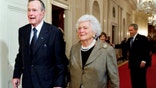 FILE - In this Jan. 7, 2009, file photo, former President George H. W. Bush, left, walks with his wife, former first lady Barbara Bush, followed by their son, President George W. Bush, and his wife first lady Laura Bush, to a reception in honor of the Points of Light Institute, in the East Room at the White House in Washington. Bush died at the age of 94 on Friday, Nov. 30, 2018, about eight months after the death of his wife, Barbara Bush. (AP Photo/Manuel Balce Ceneta, File)