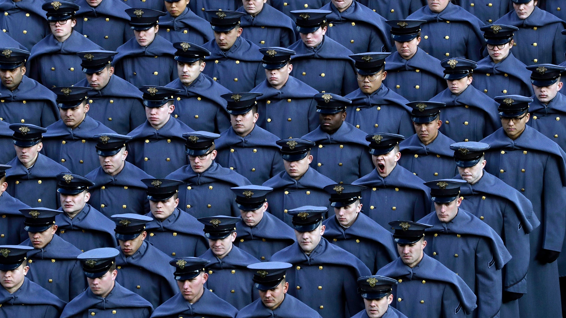 An Army cadet yawns after marching onto the field before an NCAA college football game against Navy in Philadelphia, Dec. 8, 2018.