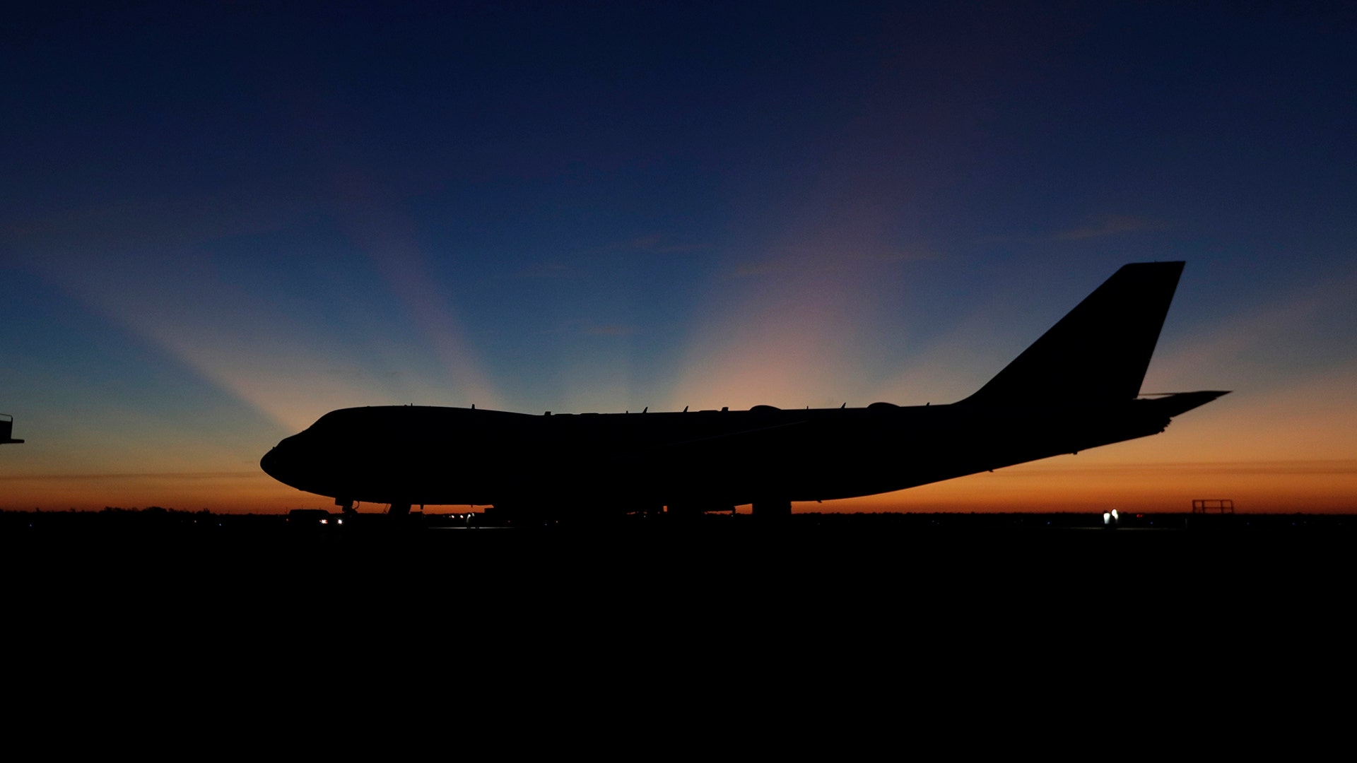 The sun rises behind Special Air Mission 41, the plane that will transfer the casket of former President George H.W. Bush to Washington, in Houston, Dec. 3, 2018. 