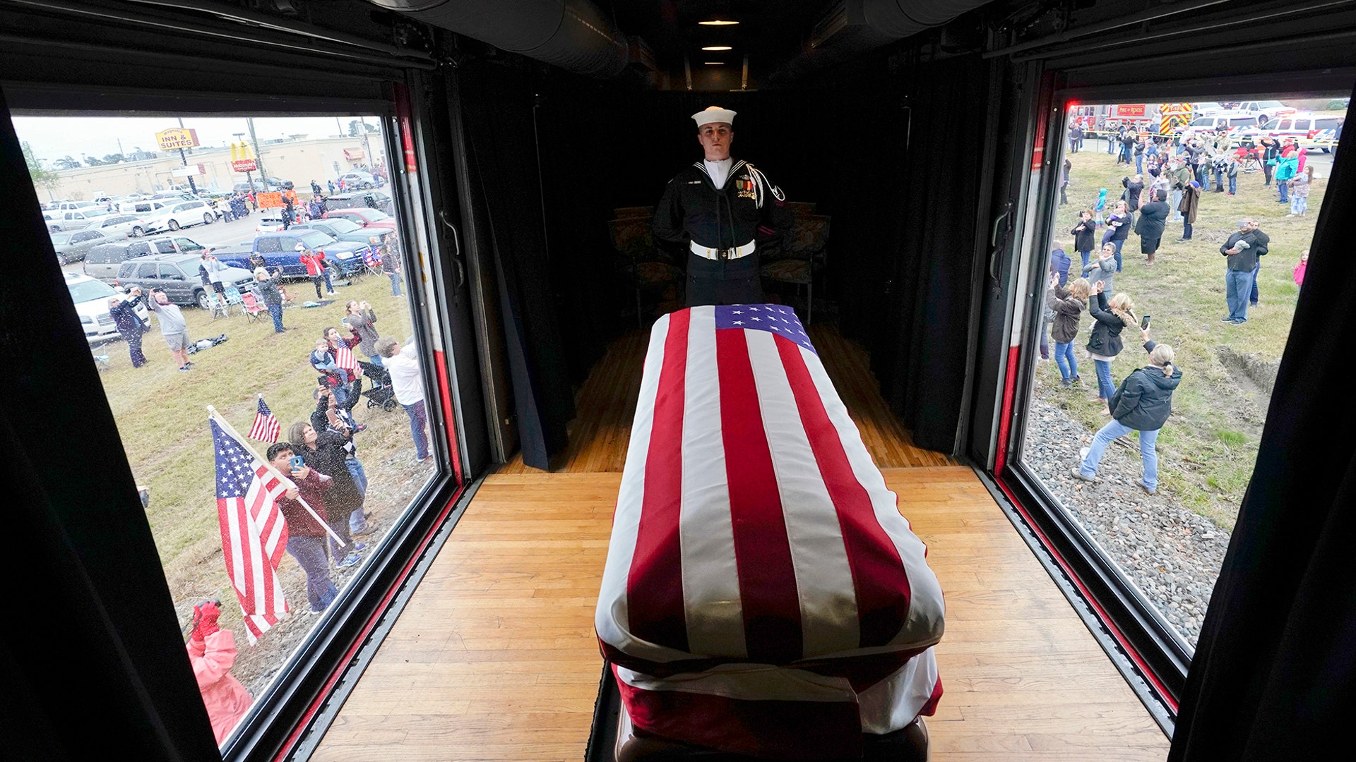 The flag-draped casket of former President George H.W. Bush passes through Magnolia, Texas, Dec. 6, 2018.