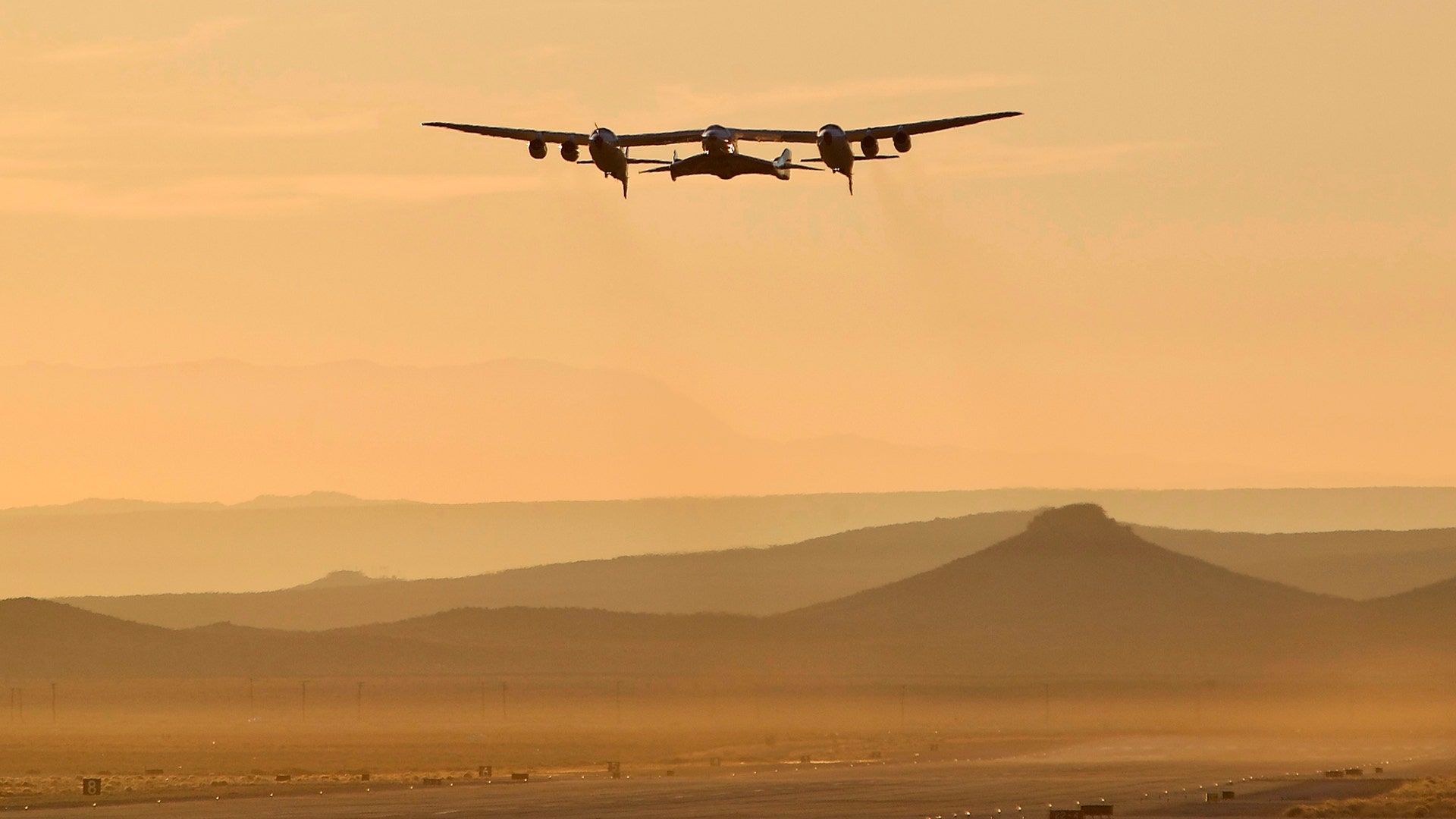 A jet carrying Virgin Galactic's tourism spaceship takes off from Mojave Air and Space Port in Mojave, Calif., Dec. 13, 2018.