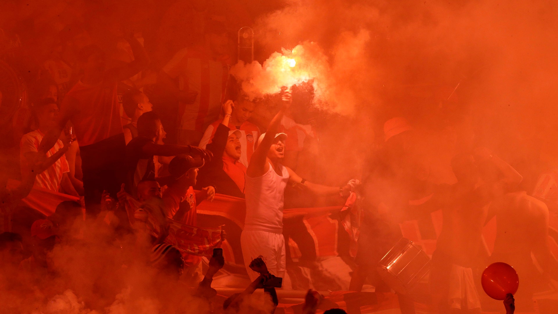 Fans of Colombia's Junior burn a flare in the stands prior a Copa Sudamericana first leg final match against Brazil's Atletico Paranaense at Metropolitano stadium in Barranquilla, Colombia, Dec. 5, 2018. 