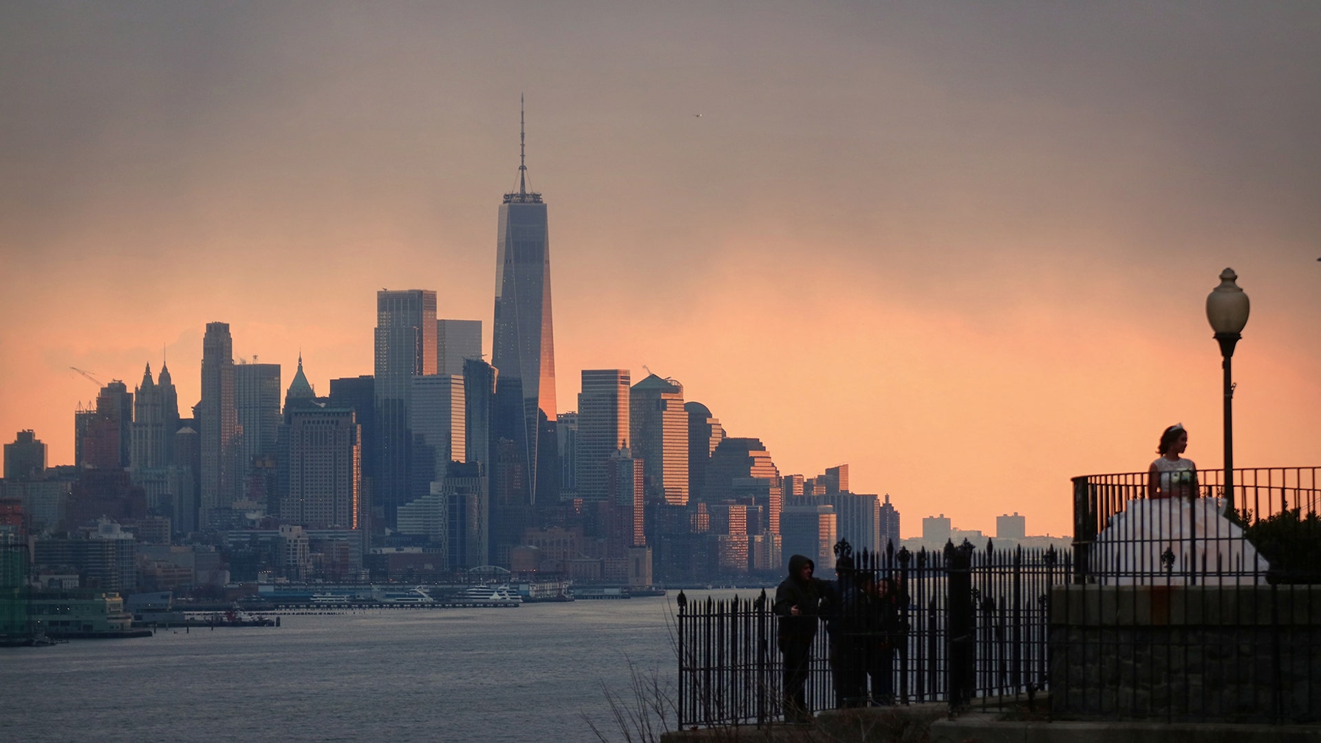 A bride poses for pictures in front of the skyline of lower Manhattan in New York City as seen from Weehawken, N.J., Dec. 8, 2018