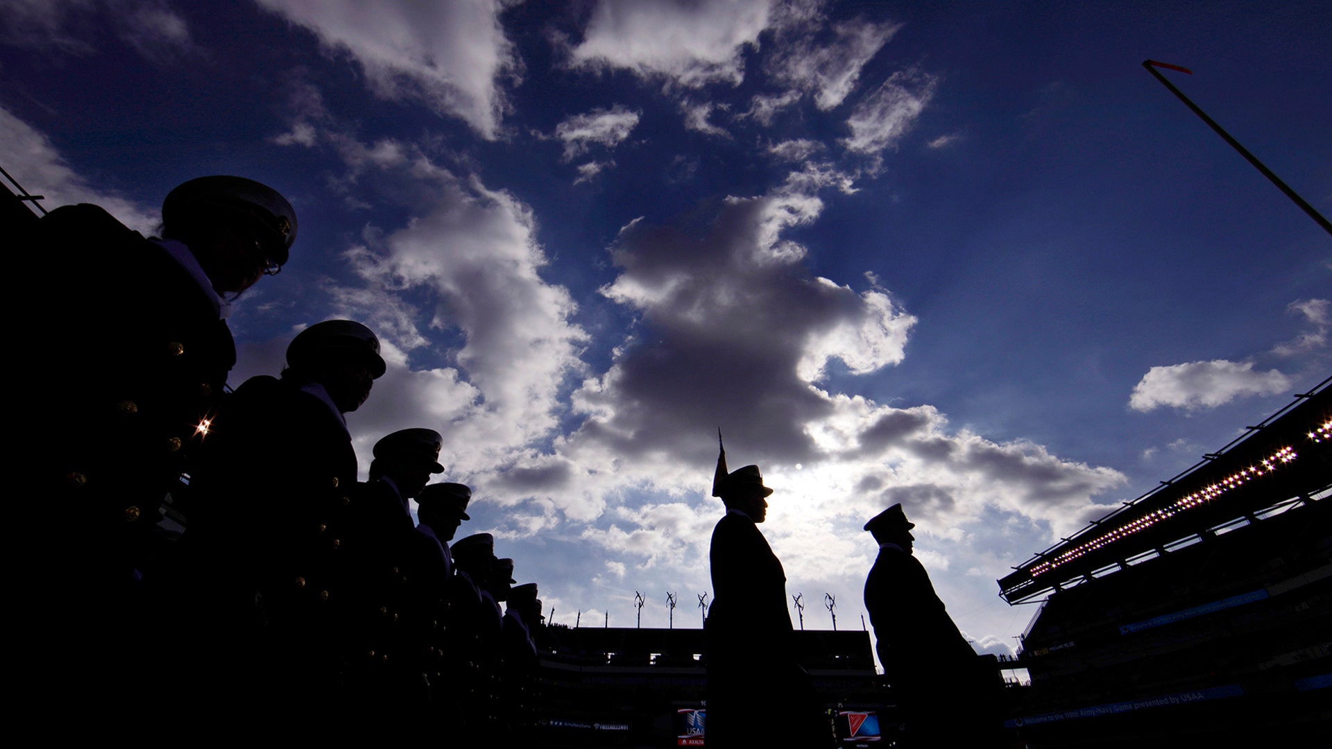 Navy Midshipmen march onto the field before an NCAA college football game against Army in Philadelphia, Dec. 8, 2018. 