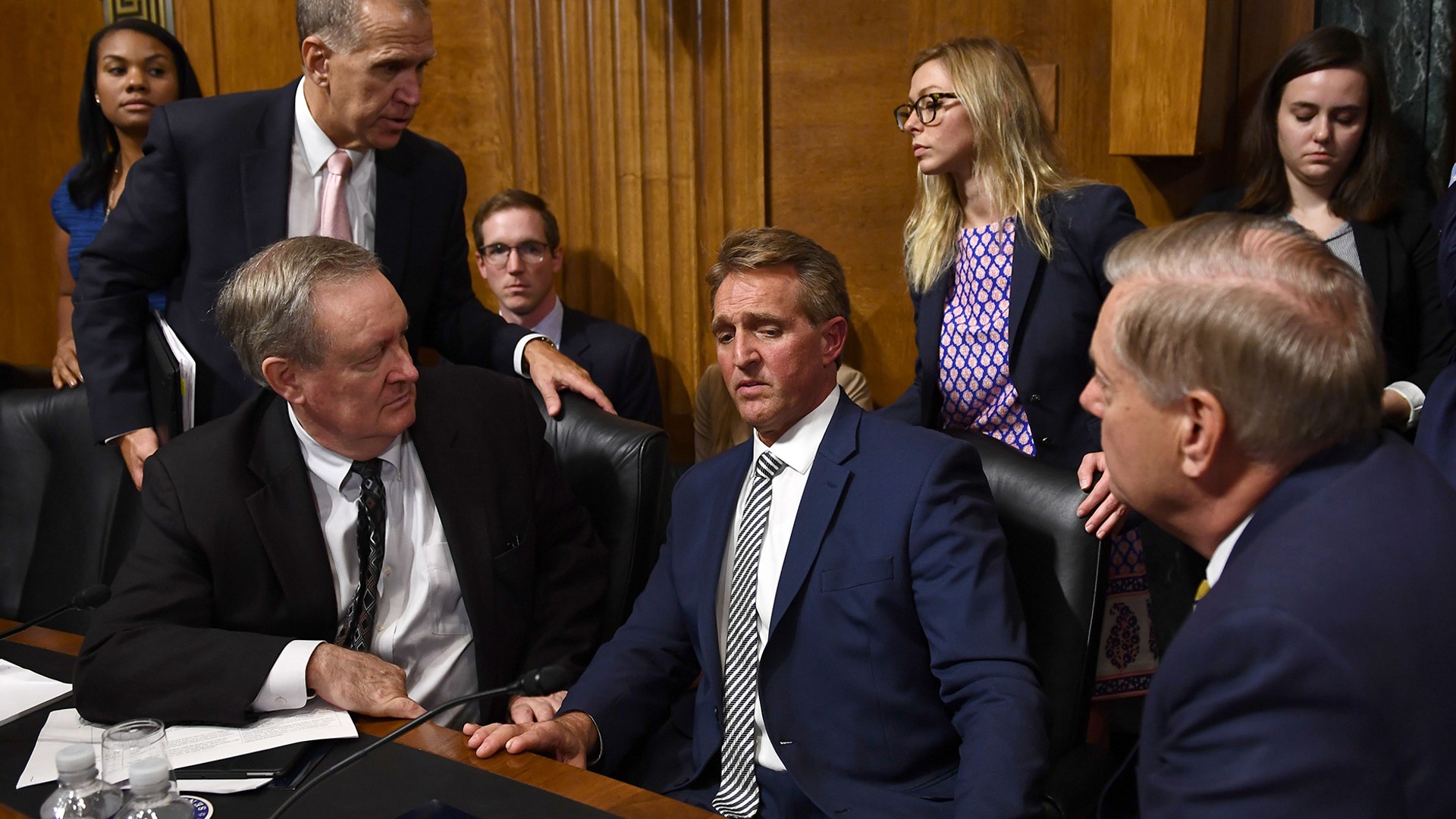 Senate Judiciary Committee member Senator Jeff Flake speaks with committee colleagues during a hearing on the nomination of Brett M. Kavanaugh to be an associate justice of the Supreme Court in Washington, September 28, 2018.