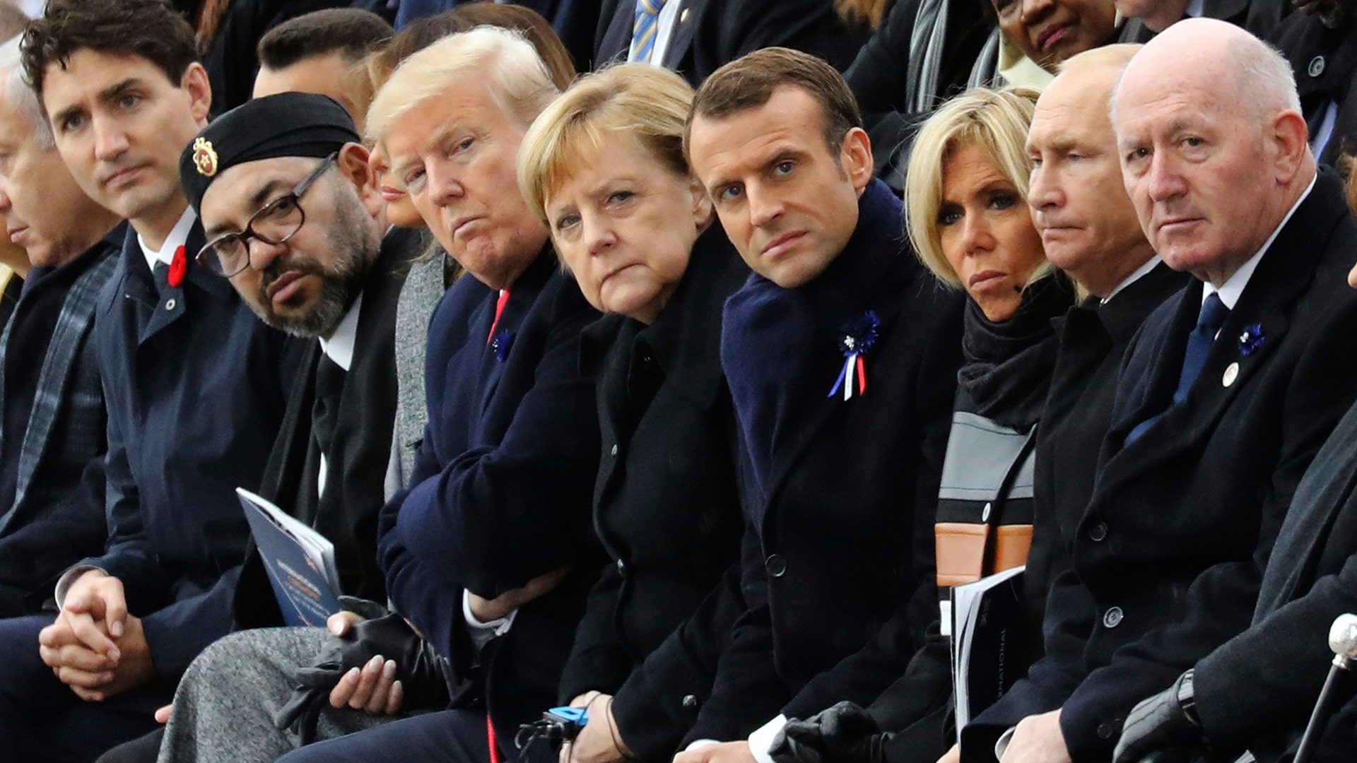 World leaders, from left, Canadian Prime Minister Justin Trudeau, Morocco's Prince Moulay Hassan, Moroccan King Mohammed VI, U.S. President Donald Trump, German Chancellor Angela Merkel, French President Emmanuel Macron and his wife Brigitte Macron, Russian President Vladimir Putin and Australian Governor-General Peter Cosgrove attend a ceremony at the Arc de Triomphe as part of the commemorations marking the 100th anniversary of the November 11, 1918, armistice, which ended World War I in Paris November 11, 2018. 