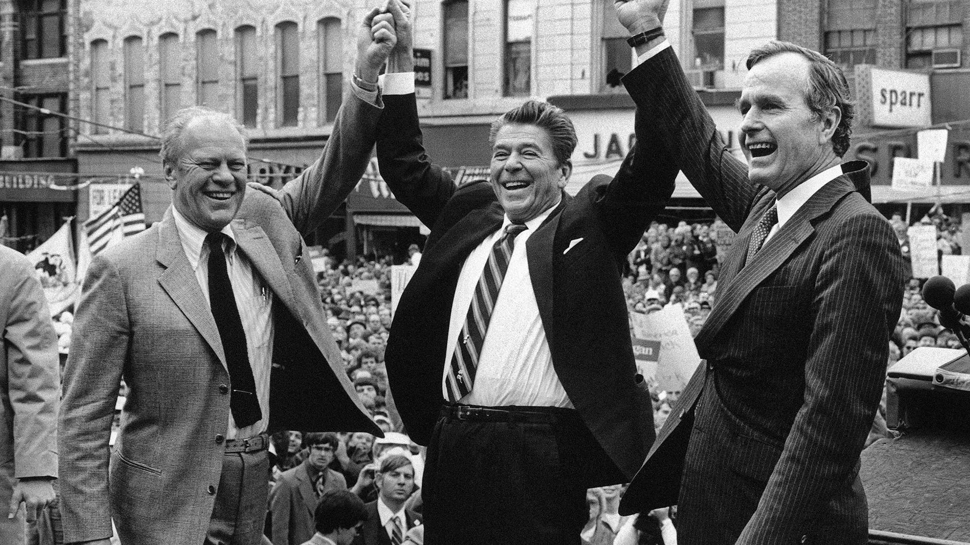 In this Nov. 3, 1980 file photo, former President Gerald Ford lends his support to Republican presidential candidate Ronald Reagan and his running mate George H.W. Bush, in Peoria, Ill. 