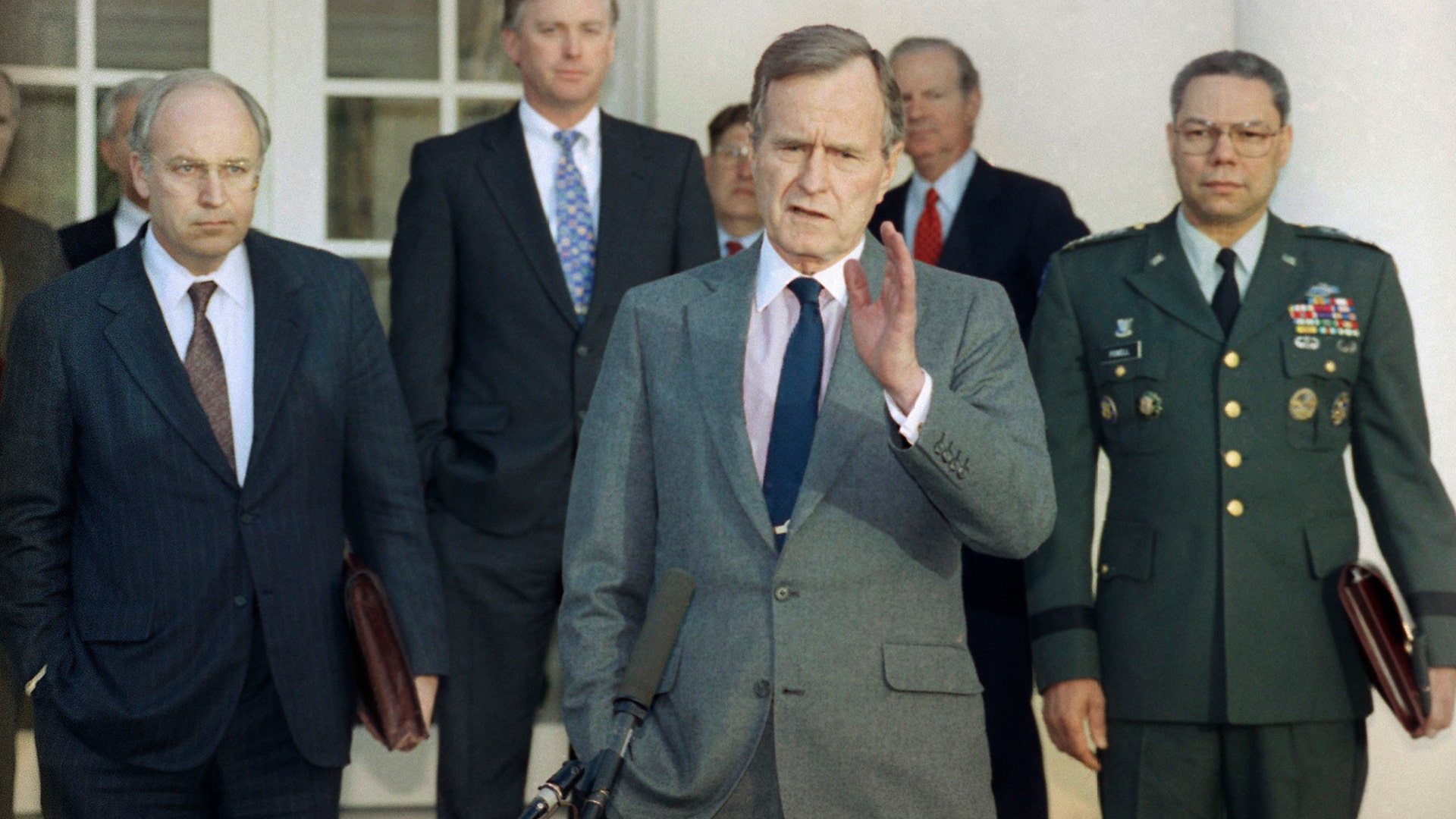 In this Feb. 11, 1991, file photo, President George H.W. Bush talks to reporters in the Rose Garden of the White House after meeting with top military advisors to discuss the Persian Gulf War. From left are, Defense Secretary Dick Cheney, Vice President Dan Quayle, White House Chief of Staff John Sununu, the president, Secretary of State James A. Baker III, and Joint Chiefs Chairman Gen. Colin Powell.