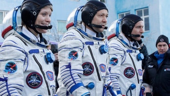 Soyuz spacecraft carrying three astronauts successfully docks with the International Space Station
