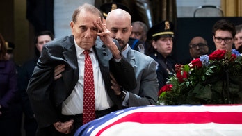 Bob Dole gives George H.W. Bush standing salute, rising from wheelchair in dramatic moment