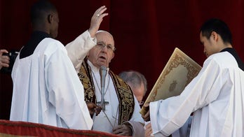 Pope Francis, in Christmas Mass, urges world to set aside 'partisan interests'