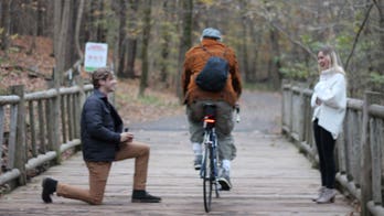 Cyclist photobombs Kentucky couple's engagement photos: 'What in the world was this guy thinking?'